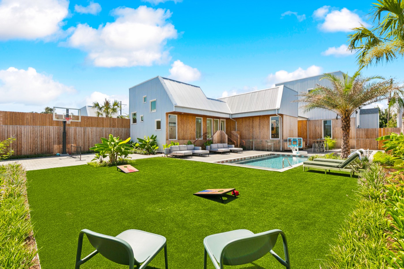 Castleday Retreats villa with private pool, lawn, and modern exterior in the Bywater